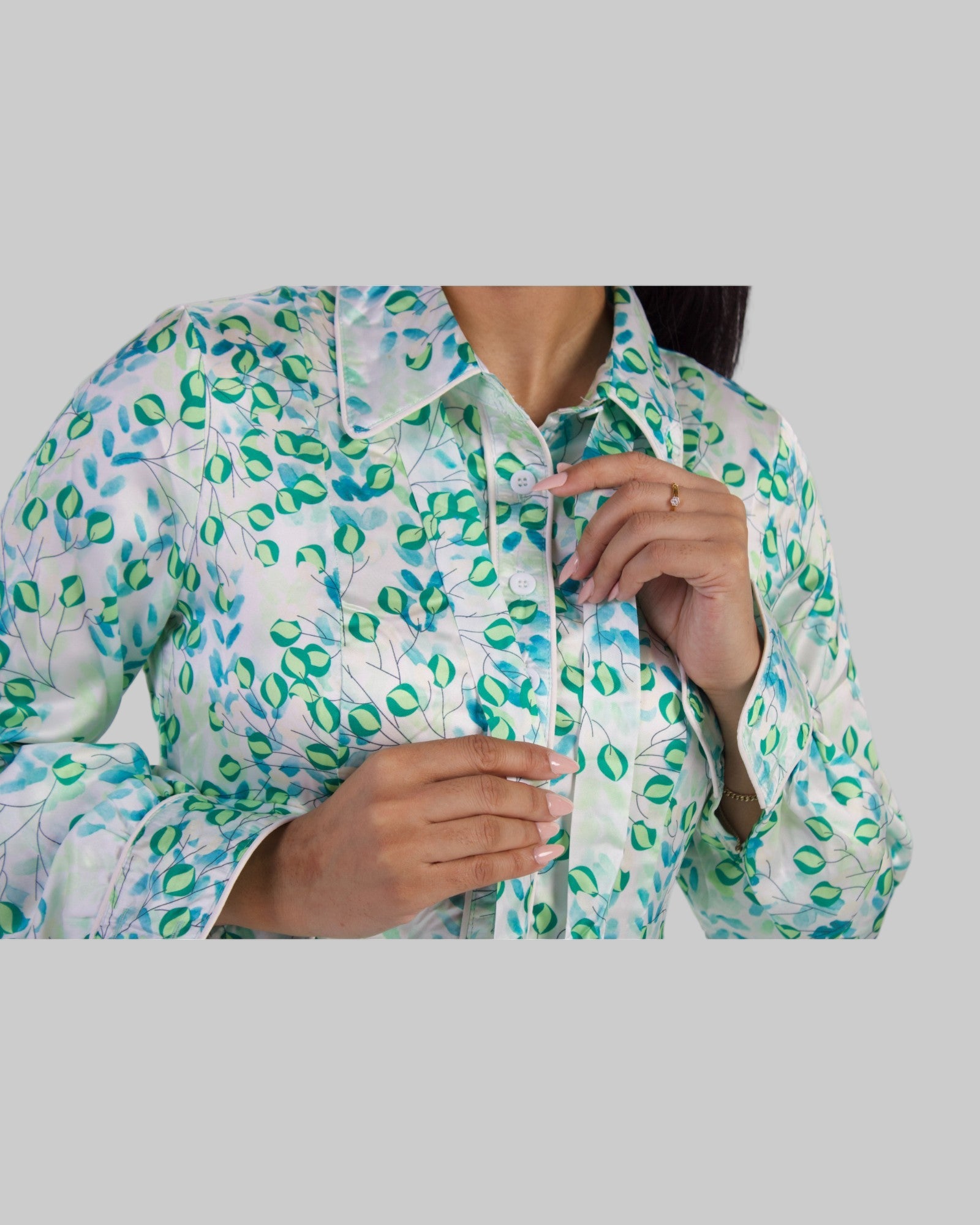 Close-up of Sage Bloom Maxi Dress bodice featuring a green leaf pattern, button-down collar, and modest long sleeves.