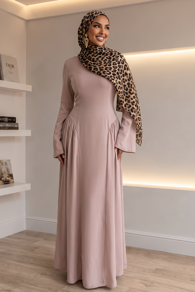 A woman wearing a long-sleeved taro maxi abaya with a matching leopard-print hijab
